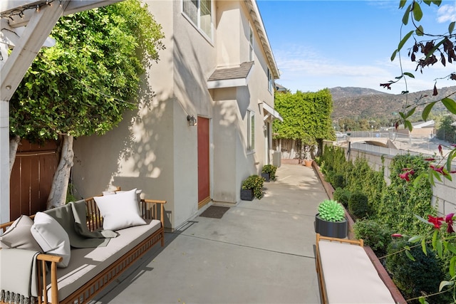 exterior space featuring a mountain view and a patio area