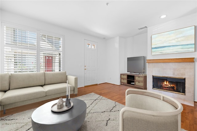 living room with a fireplace and hardwood / wood-style flooring