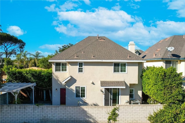 rear view of property with a pergola