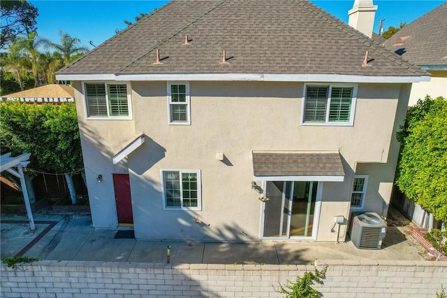 rear view of property featuring central AC unit and a patio