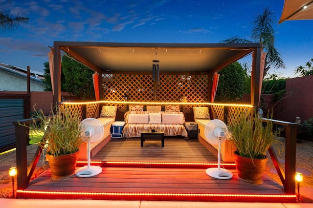 deck at dusk featuring an outdoor living space