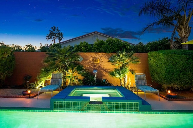 view of swimming pool featuring a patio area and an in ground hot tub