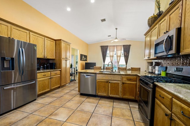 kitchen with decorative backsplash, sink, stainless steel appliances, and lofted ceiling