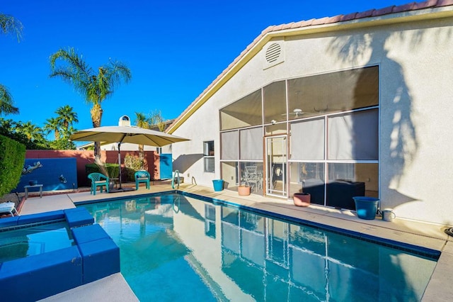 view of swimming pool with a patio area and a hot tub