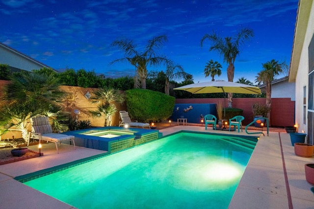 view of pool featuring a patio area and an in ground hot tub