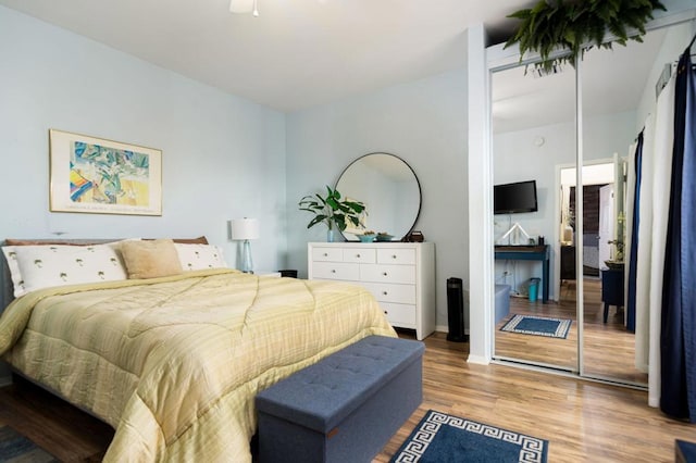 bedroom featuring hardwood / wood-style floors, a closet, and ceiling fan