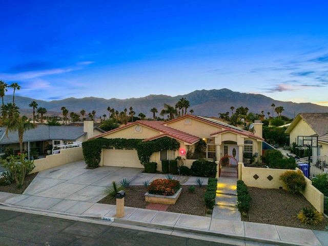 view of front of house featuring a mountain view and a garage