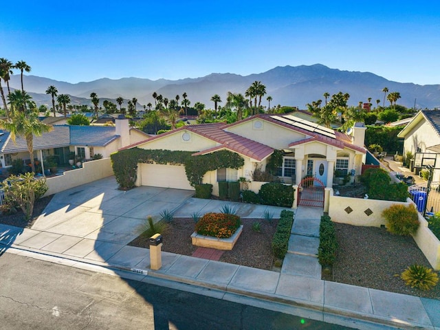 mediterranean / spanish house with a mountain view and a garage