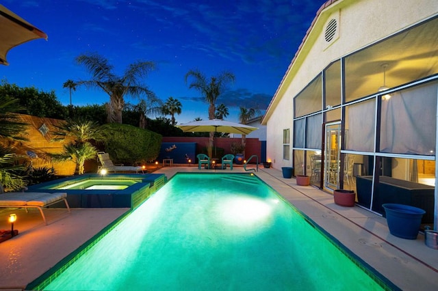 view of swimming pool with an in ground hot tub and a patio