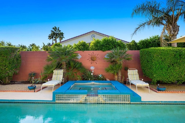 view of pool with an in ground hot tub