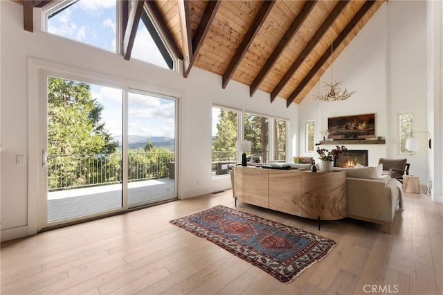 living room featuring light hardwood / wood-style floors, high vaulted ceiling, and a wealth of natural light