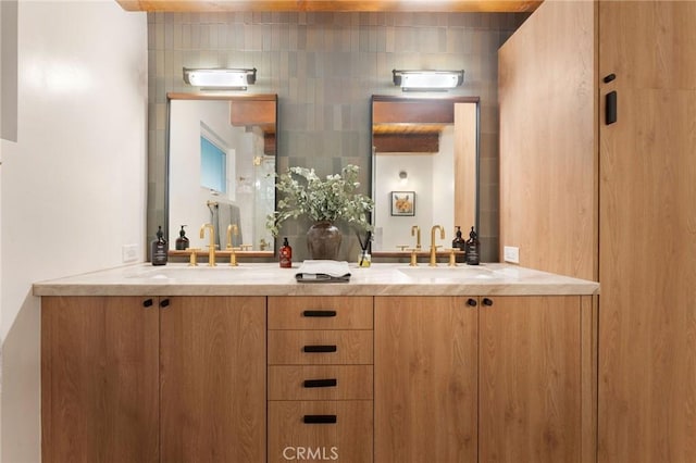 bar with light stone counters, sink, and tasteful backsplash