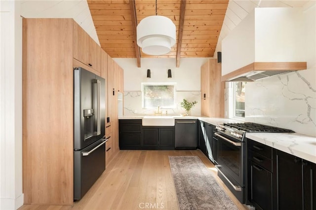 kitchen with pendant lighting, appliances with stainless steel finishes, a healthy amount of sunlight, and custom exhaust hood