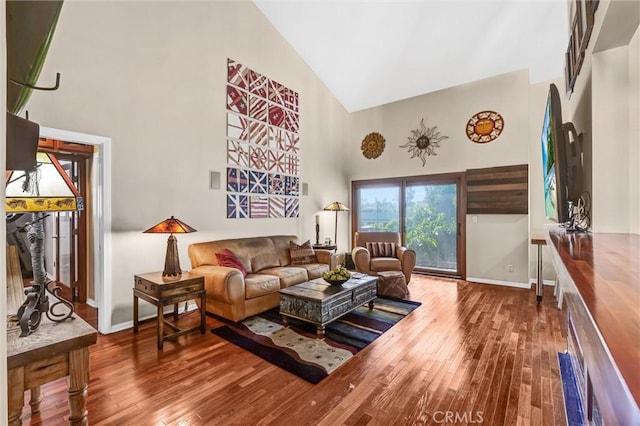 living room featuring hardwood / wood-style flooring and high vaulted ceiling