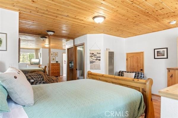 bedroom featuring hardwood / wood-style floors and wood ceiling