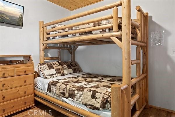 bedroom featuring hardwood / wood-style floors and wood ceiling