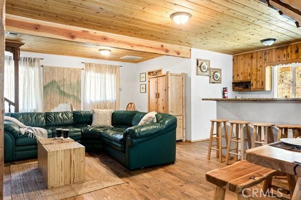 33544 Green Valley Lake Rd, Green Valley Lake, CA 92341 - living area with plenty of natural light, wooden ceiling, and light wood-style floors
