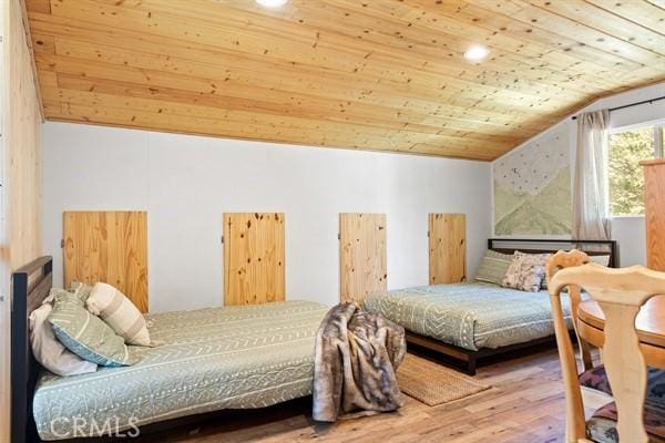 bedroom featuring lofted ceiling, wood-type flooring, and wood ceiling