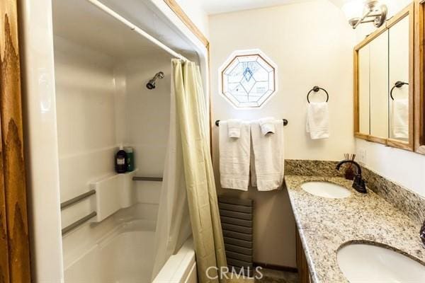 bathroom featuring vanity and shower / bath combo