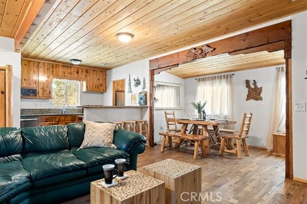 living room with wood ceiling and light hardwood / wood-style flooring