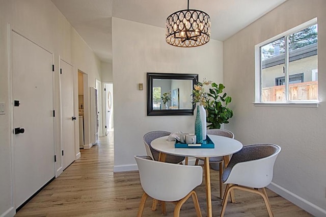 dining space with an inviting chandelier and light wood-type flooring