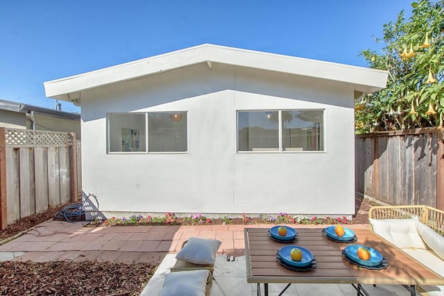 view of side of property with a patio