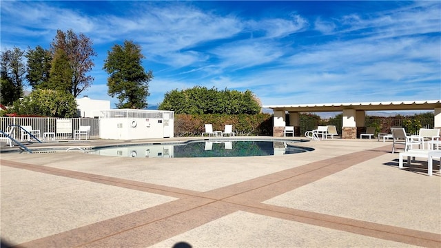 view of swimming pool featuring a patio area and a fireplace