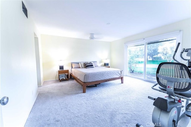 bedroom with access to exterior, light colored carpet, and ceiling fan