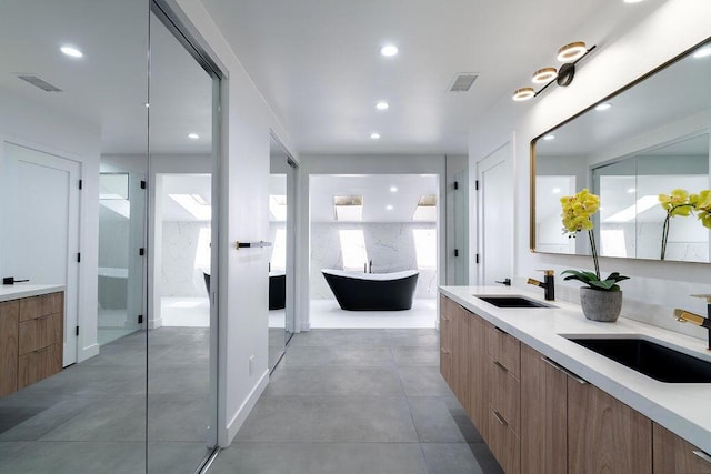 bathroom featuring vanity and a tub to relax in