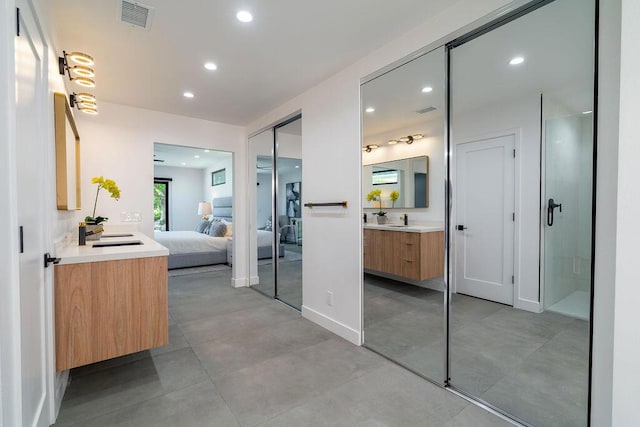 bathroom featuring vanity and concrete flooring