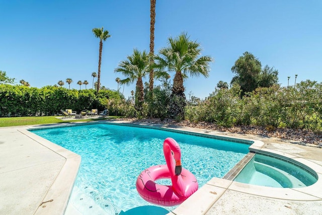 view of pool with an in ground hot tub