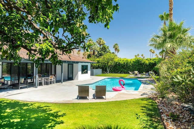 view of pool featuring a yard and a patio