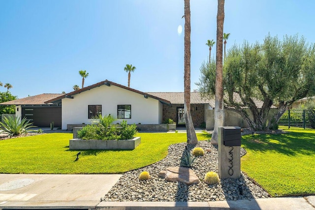 ranch-style home with a front yard and a garage