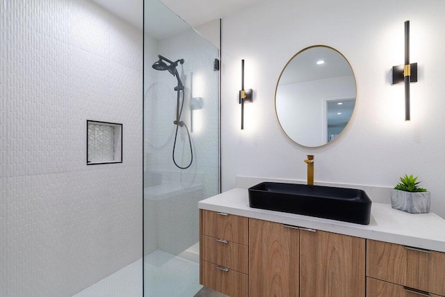 bathroom with vanity and a tile shower