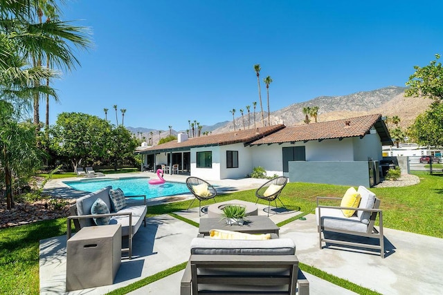 back of house featuring a mountain view, an outdoor hangout area, and a patio