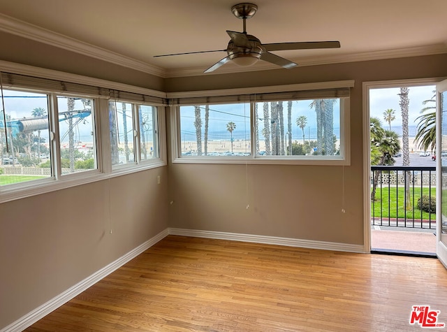 unfurnished sunroom featuring ceiling fan