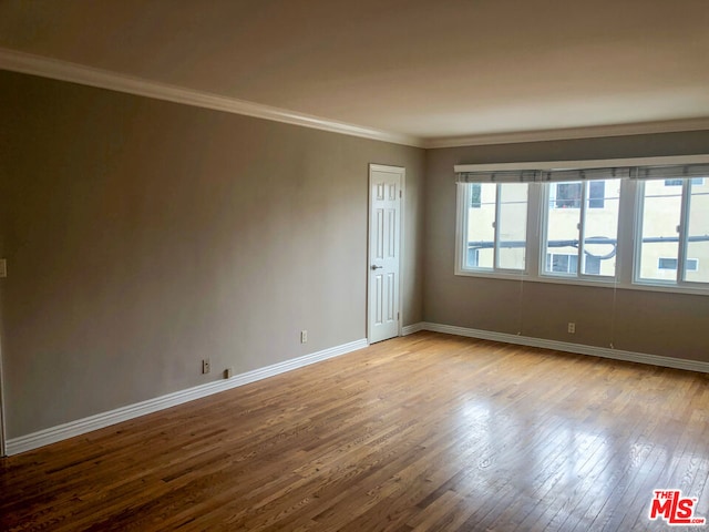 unfurnished room featuring light hardwood / wood-style floors and ornamental molding