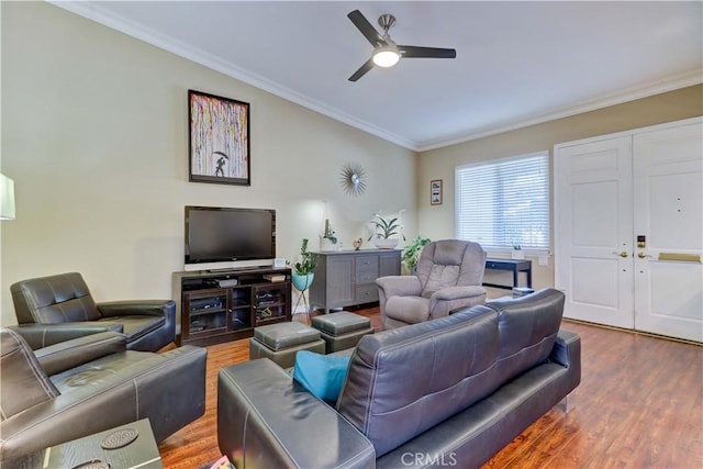 living room featuring ceiling fan, crown molding, and wood-type flooring