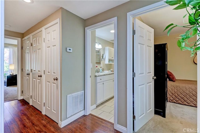 corridor featuring light colored carpet