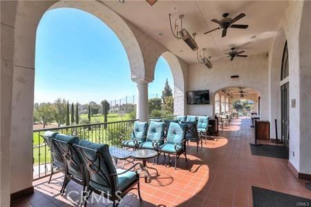 view of patio featuring ceiling fan and a balcony