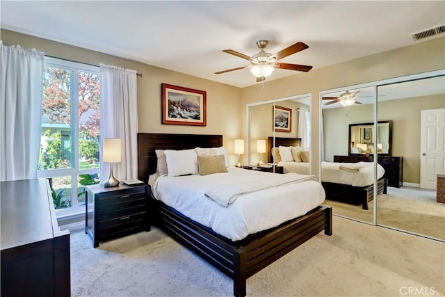 carpeted bedroom featuring ceiling fan and multiple windows