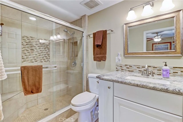 bathroom with ceiling fan, walk in shower, tasteful backsplash, and toilet