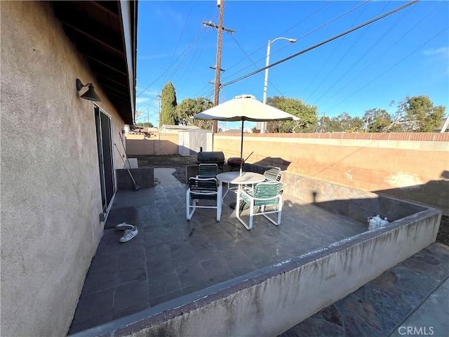 view of patio / terrace with a storage shed