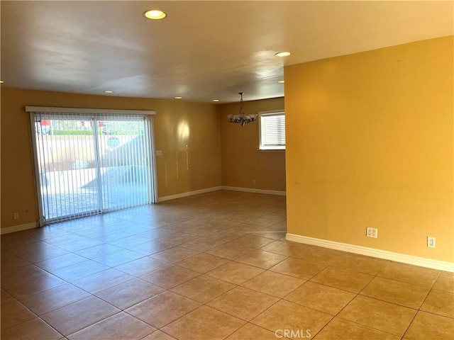 unfurnished room with light tile patterned floors and an inviting chandelier