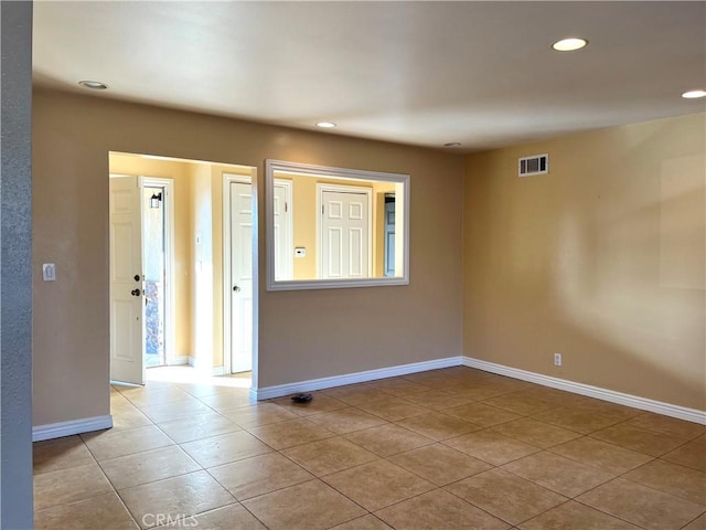 unfurnished room with light tile patterned floors