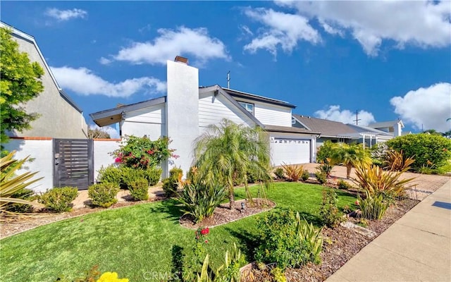 view of side of property with a lawn and a garage