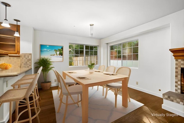 dining room featuring dark hardwood / wood-style floors and a fireplace