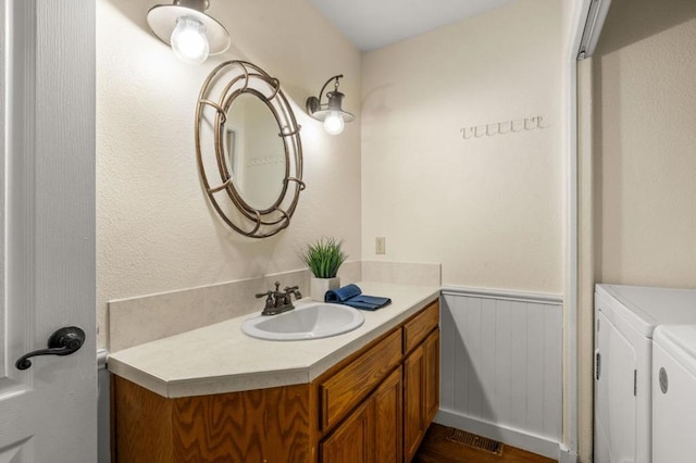 bathroom featuring vanity and washer and dryer