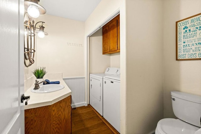 bathroom featuring vanity, separate washer and dryer, wood-type flooring, and toilet