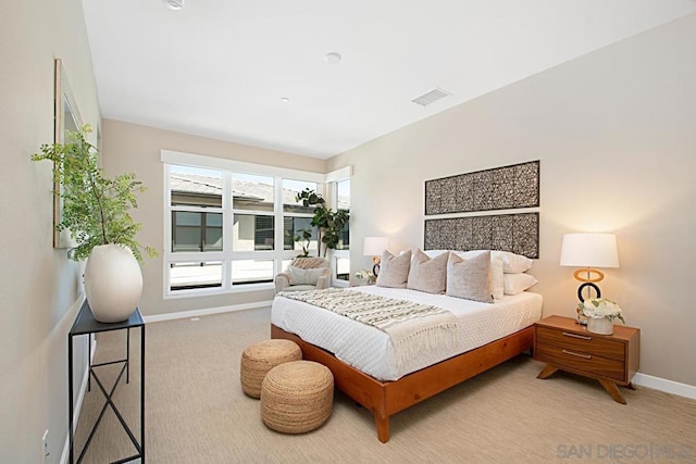 bedroom featuring light colored carpet